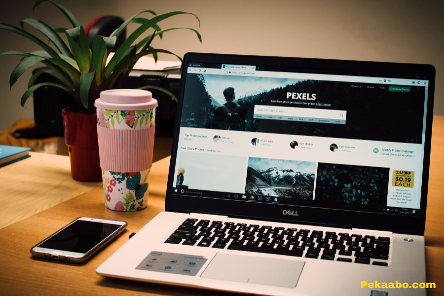 Website Optimization Services for Faster, Higher-Converting Pages 2 Laptop showing website content on a desk with coffee and plant for digital marketing work