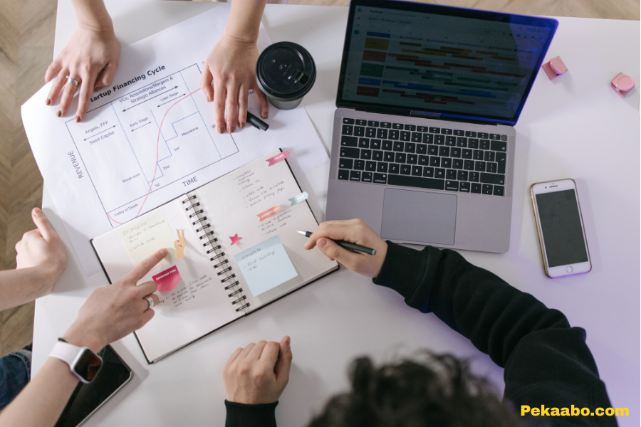 Website Optimization Services for Faster, Higher-Converting Pages 1 Team planning digital marketing strategy with laptop, notes, and startup growth chart