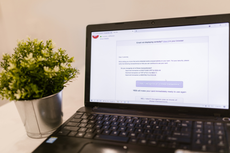Laptop displaying a suspicious transaction email highlighting email security and phishing risks