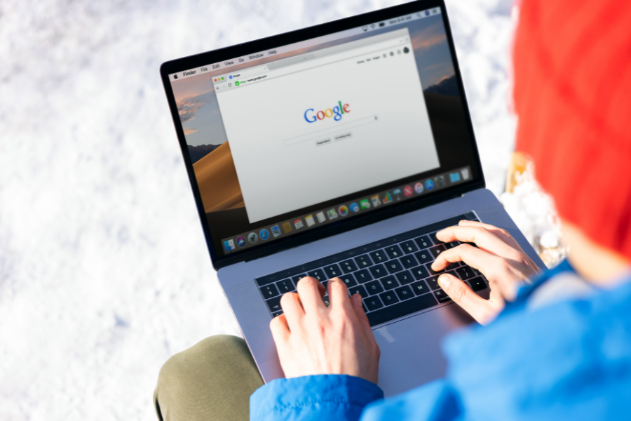 SEO Services for SaaS Companies: From Keyword Demand to Pipeline 1 Person researching SEO services for SaaS companies using Google on a laptop
